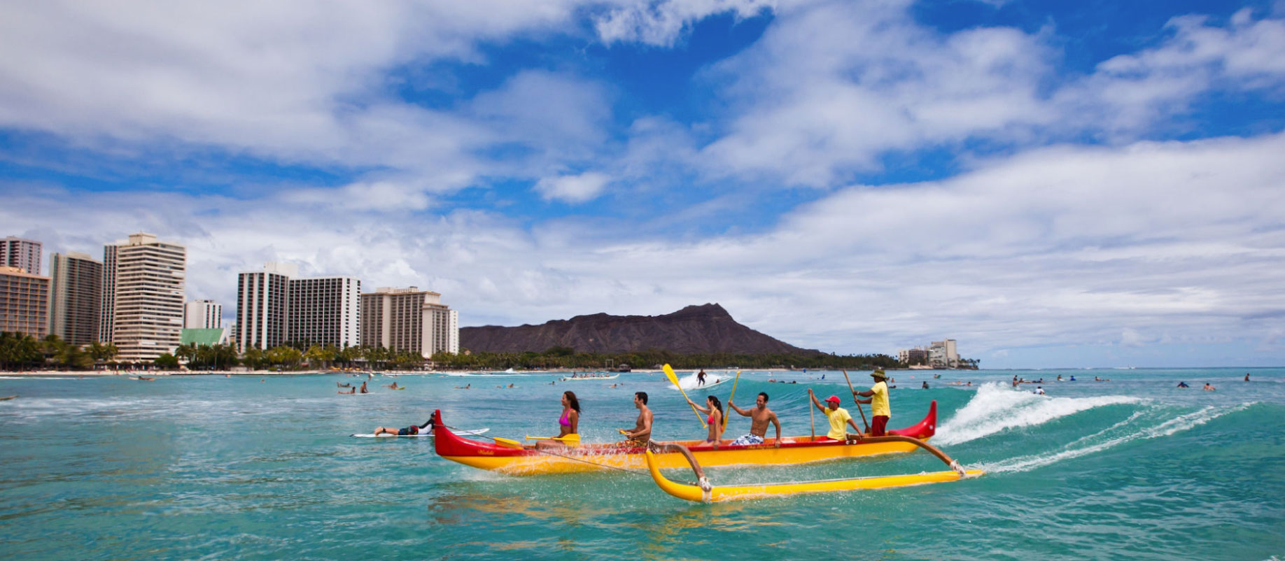 People paddling in the ocean on a canoe