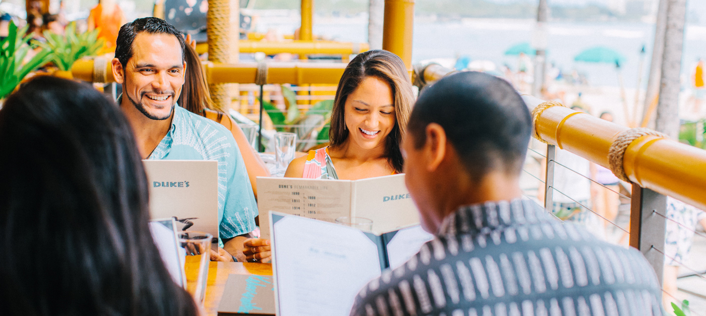 Guests outside looking at the menu