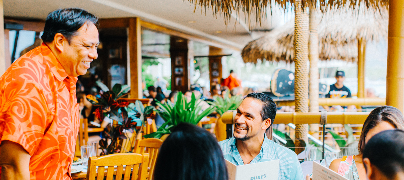 Waiter talking with guests