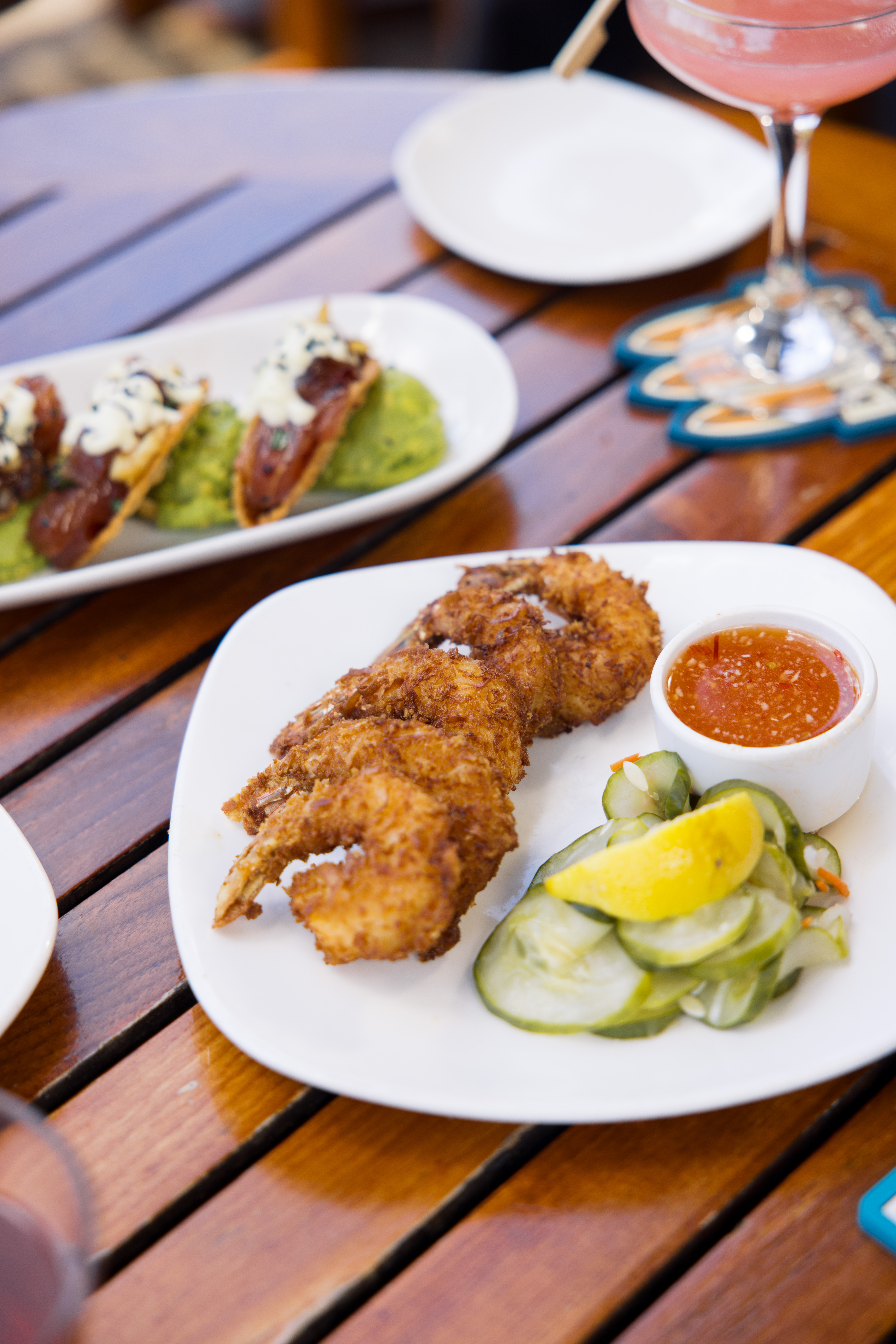 coconut shrimp & poke taco appetizer plated on the table